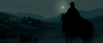 Movie still from “The Legend of Zorro” (2005), directed by Martin Campbell – A man riding a horse in a field at night; Wide shot, Low angle
