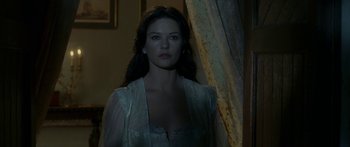 Movie still from “The Legend of Zorro” (2005), directed by Martin Campbell – A beautiful woman standing in front of a curtain; Medium shot, Over the shoulder angle