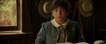 Movie still from “The Legend of Zorro” (2005), directed by Martin Campbell – A young boy wearing a blue jacket and a tie; Close Up shot, Over the shoulder angle
