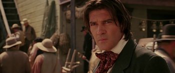 Movie still from “The Legend of Zorro” (2005), directed by Martin Campbell – A person wearing a suit and tie; Close Up shot, Over the shoulder angle