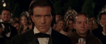 Movie still from “The Legend of Zorro” (2005), directed by Martin Campbell – A person wearing a suit and bow tie; Close Up shot, Over the shoulder angle