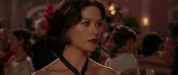 Movie still from “The Legend of Zorro” (2005), directed by Martin Campbell – A beautiful woman with dark brown hair wearing a necklace; Close Up shot, Over the shoulder angle