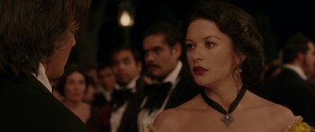 Movie still from “The Legend of Zorro” (2005), directed by Martin Campbell – A group of men and women in tuxedos and dresses; Close Up shot, Over the shoulder angle