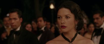 Movie still from “The Legend of Zorro” (2005), directed by Martin Campbell – A woman wearing a necklace in front of a crowd; Close Up shot, Over the shoulder angle