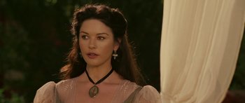 Movie still from “The Legend of Zorro” (2005), directed by Martin Campbell – A woman with long dark hair wearing a necklace; Close Up shot, Over the shoulder angle