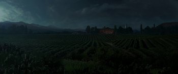 Movie still from “The Legend of Zorro” (2005), directed by Martin Campbell – A field with a house in the background at night time; Extreme Wide shot, High angle