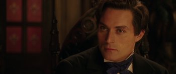 Movie still from “The Legend of Zorro” (2005), directed by Martin Campbell – A person wearing a suit and a bow tie; Close Up shot, Over the shoulder angle