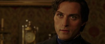 Movie still from “The Legend of Zorro” (2005), directed by Martin Campbell – A person wearing a suit and tie; Close Up shot, Over the shoulder angle