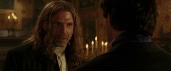 Movie still from “The Legend of Zorro” (2005), directed by Martin Campbell – A man with long brown hair talking to another man in a suit; Close Up shot, Over the shoulder angle