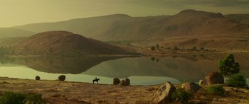 Movie still from “The Legend of Zorro” (2005), directed by Martin Campbell – A horse and some sheep are by a lake; Extreme Wide shot, High angle