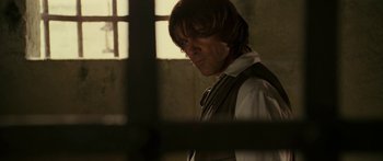 Movie still from “The Legend of Zorro” (2005), directed by Martin Campbell – A man with long hair wearing a vest and a tie; Close Up shot, Over the shoulder angle