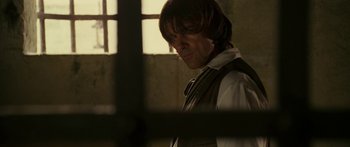 Movie still from “The Legend of Zorro” (2005), directed by Martin Campbell – A man with long hair wearing a vest and a tie; Close Up shot, Over the shoulder angle
