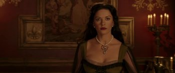 Movie still from “The Legend of Zorro” (2005), directed by Martin Campbell – A woman in a green dress with a pearl necklace; Close Up shot, Over the shoulder angle