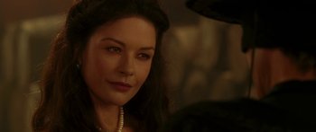 Movie still from “The Legend of Zorro” (2005), directed by Martin Campbell – A person wearing a pearl necklace; Close Up shot, Over the shoulder angle