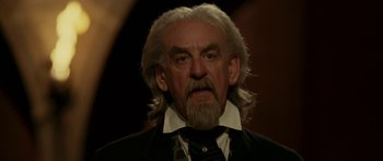 Movie still from “The Legend of Zorro” (2005), directed by Martin Campbell – An old man with long white hair and a beard; Close Up shot, Low angle