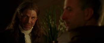 Movie still from “The Legend of Zorro” (2005), directed by Martin Campbell – A man with long hair is sitting next to another man with long hair; Close Up shot, Over the shoulder angle