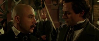 Movie still from “The Legend of Zorro” (2005), directed by Martin Campbell – Two men in suits are talking to each other; Close Up shot, Over the shoulder angle