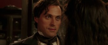 Movie still from “The Legend of Zorro” (2005), directed by Martin Campbell – A person wearing a suit and tie; Close Up shot, Over the shoulder angle