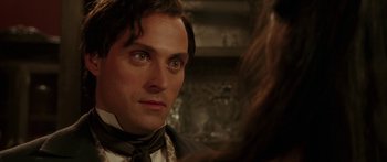 Movie still from “The Legend of Zorro” (2005), directed by Martin Campbell – A person wearing a suit and tie; Close Up shot, Over the shoulder angle