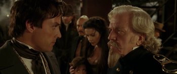 Movie still from “The Legend of Zorro” (2005), directed by Martin Campbell – A man with long white hair and a long beard is talking to a man with long white hair; Close Up shot, Over the shoulder angle