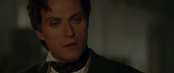 Movie still from “The Legend of Zorro” (2005), directed by Martin Campbell – A person wearing a suit and tie; Close Up shot, Over the shoulder angle