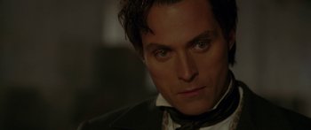 Movie still from “The Legend of Zorro” (2005), directed by Martin Campbell – A person wearing a suit and tie; Close Up shot, Over the shoulder angle