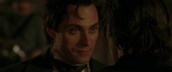 Movie still from “The Legend of Zorro” (2005), directed by Martin Campbell – A person wearing a suit and tie; Close Up shot, Over the shoulder angle