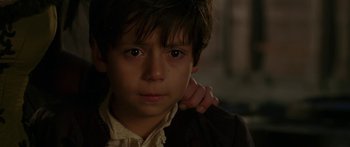 Movie still from “The Legend of Zorro” (2005), directed by Martin Campbell – A young boy with his hand on his shoulder looking at the camera; Close Up shot, Over the shoulder angle