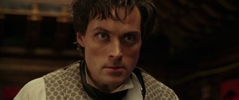 Movie still from “The Legend of Zorro” (2005), directed by Martin Campbell – A person wearing a suit and tie; Close Up shot, High angle