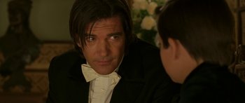 Movie still from “The Legend of Zorro” (2005), directed by Martin Campbell – A person wearing a suit and bow tie; Close Up shot, Over the shoulder angle