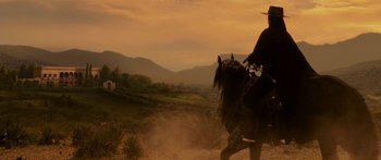 Movie still from “The Legend of Zorro” (2005), directed by Martin Campbell – A man riding a horse in the middle of the desert; Wide shot, Low angle