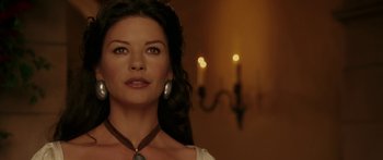 Movie still from “The Legend of Zorro” (2005), directed by Martin Campbell – A beautiful woman with long black hair wearing a necklace; Close Up shot, Over the shoulder angle