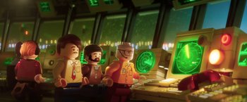 Movie still from “The Lego Batman Movie” (2017), directed by Chris McKay – A group of lego figures in front of a computer monitor; Close Up shot, Over the shoulder angle