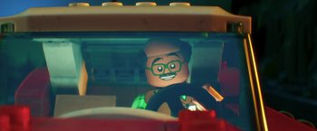 Movie still from “The Lego Batman Movie” (2017), directed by Chris McKay – A lego man driving a car in the dark; Close Up shot, Over the shoulder angle