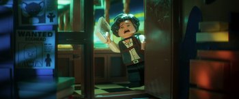 Movie still from “The Lego Batman Movie” (2017), directed by Chris McKay – A lego figure is holding a piece of paper in front of a mirror; Close Up shot, Over the shoulder angle