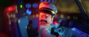 Movie still from “The Lego Batman Movie” (2017), directed by Chris McKay – A lego man that is wearing a hat; Close Up shot, Over the shoulder angle