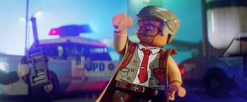Movie still from “The Lego Batman Movie” (2017), directed by Chris McKay – A man that is wearing a hat and glasses; Close Up shot, Over the shoulder angle