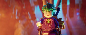 Movie still from “The Lego Batman Movie” (2017), directed by Chris McKay – A lego joker sitting on top of a wooden chair; Close Up shot, Over the shoulder angle