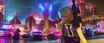 Movie still from “The Lego Batman Movie” (2017), directed by Chris McKay – A lego character in front of a building with lights; Wide shot, Low angle
