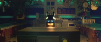 Movie still from “The Lego Batman Movie” (2017), directed by Chris McKay – A batman mask sitting on top of a table; Close Up shot, Over the shoulder angle