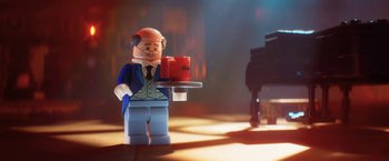 Movie still from “The Lego Batman Movie” (2017), directed by Chris McKay – A man that is holding a cup of coffee; Medium shot, Over the shoulder angle