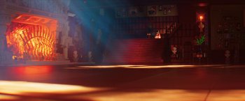 Movie still from “The Lego Batman Movie” (2017), directed by Chris McKay – A person sitting on the steps of a stage; Extreme Wide shot, Low angle