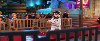 Movie still from “The Lego Batman Movie” (2017), directed by Chris McKay – A toy figure of a man wearing a bow tie; Close Up shot, Over the shoulder angle