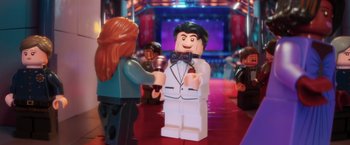 Movie still from “The Lego Batman Movie” (2017), directed by Chris McKay – A couple of people that are standing in a room; Wide shot, Over the shoulder angle