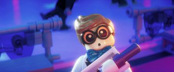 Movie still from “The Lego Batman Movie” (2017), directed by Chris McKay – A lego figure wearing a lab coat and bow tie; Close Up shot, Over the shoulder angle