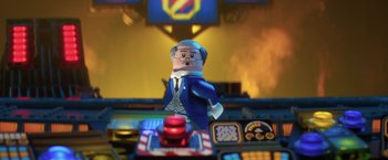 Movie still from “The Lego Batman Movie” (2017), directed by Chris McKay – A lego figure is standing in front of a table; Close Up shot, Over the shoulder angle