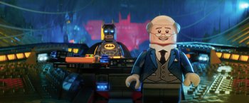 Movie still from “The Lego Batman Movie” (2017), directed by Chris McKay – A lego batman movie scene with batman and commissioner gordon in the background; Medium shot, Over the shoulder angle