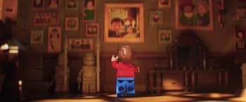 Movie still from “The Lego Batman Movie” (2017), directed by Chris McKay – A lego figure is standing in front of a picture; Extreme Close Up shot, Over the shoulder angle
