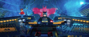 Movie still from “The Lego Batman Movie” (2017), directed by Chris McKay – A lego batman figure sitting on top of a table; Wide shot, Over the shoulder angle