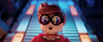 Movie still from “The Lego Batman Movie” (2017), directed by Chris McKay – A lego figure wearing glasses; Close Up shot, Overhead angle